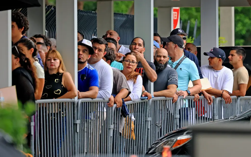 People wait in line to get inside the ICE Enforcement...