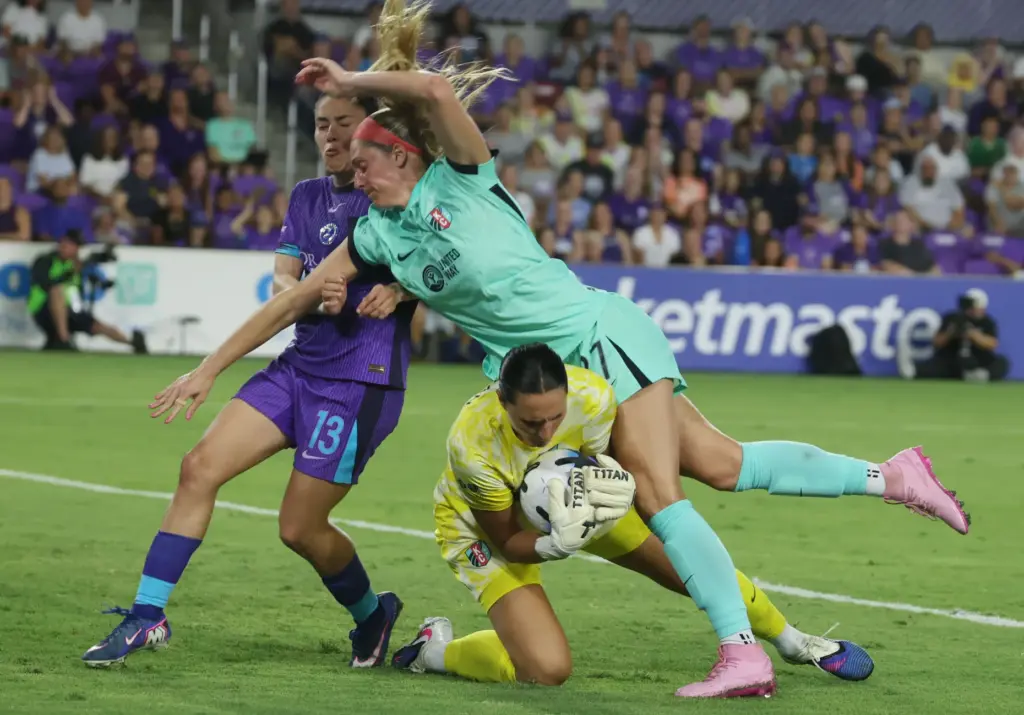 Kansas City player Kayla Sharples (27) tumbles into her own...