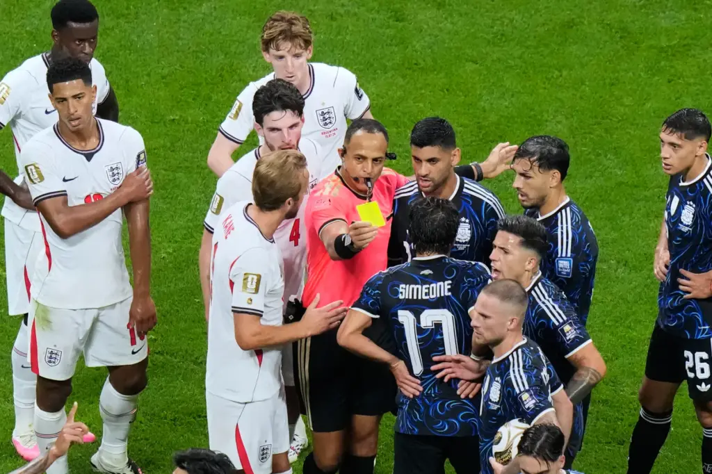 Referee Ismail Elfath, of the United States, separates players as...