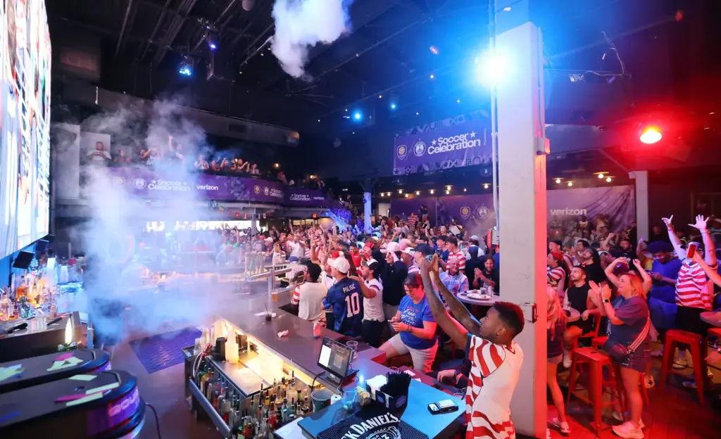 USA soccer fans cheer after a USA goal during a...
