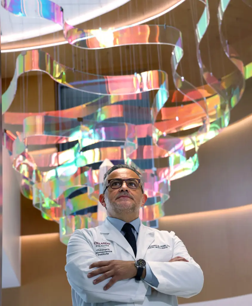 Orlando Health Chief of Pediatric Neurosurgery Dr. Samer Elbabaa listens...