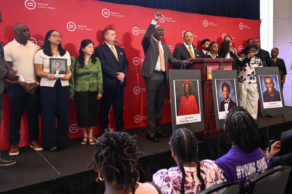 Attorney Ben Crump shouts from the podium as he joins...