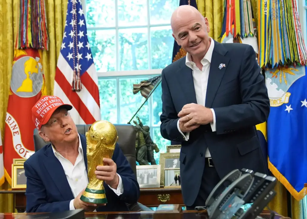 FILE – President Donald Trump holds the FIFA World Cup...
