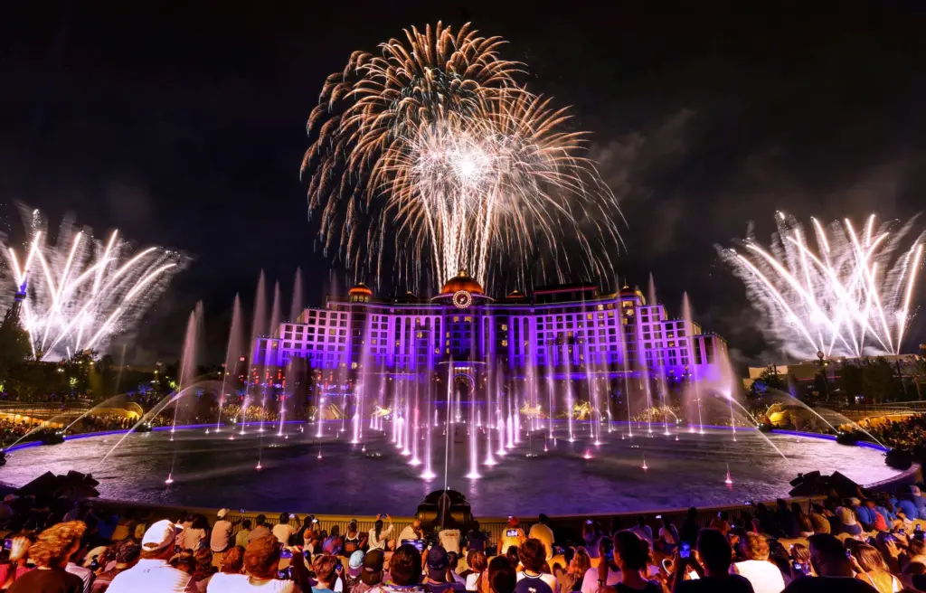 Guests watch the debut of the first nighttime finale fireworks...