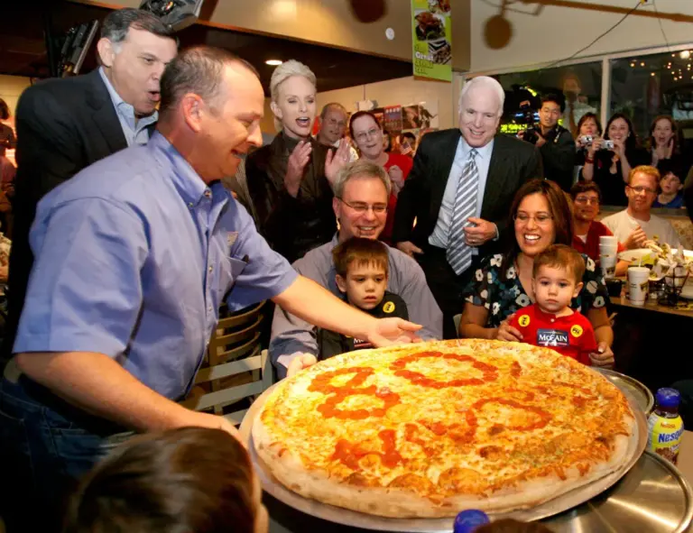 Sen. John McCain laughs with Sen. Mel Martinez (far left)...