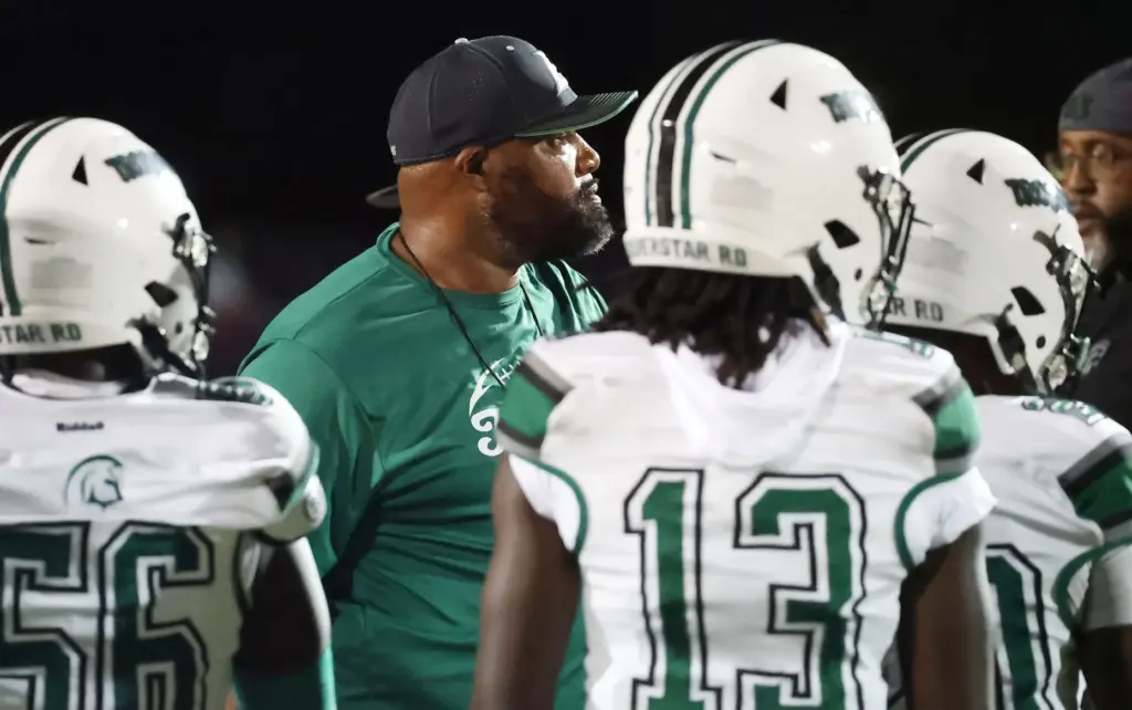 Evans High coach Karlos Odum coaches players during the Evans...