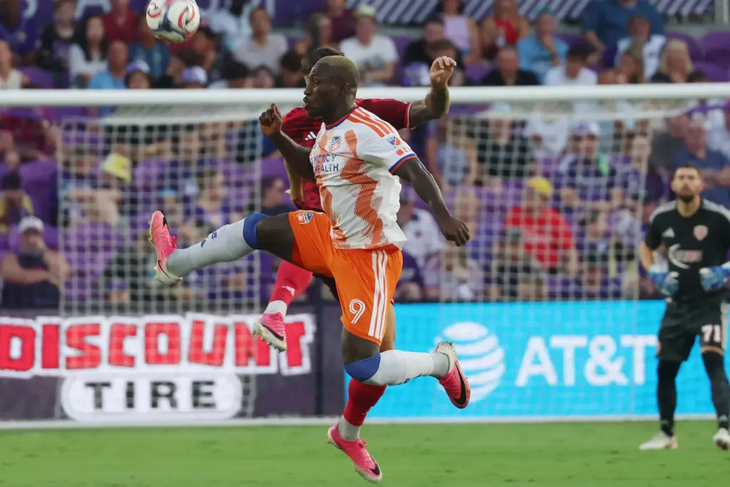 Cincinnati player Kevin Denkey (9) leaps to control the ball...