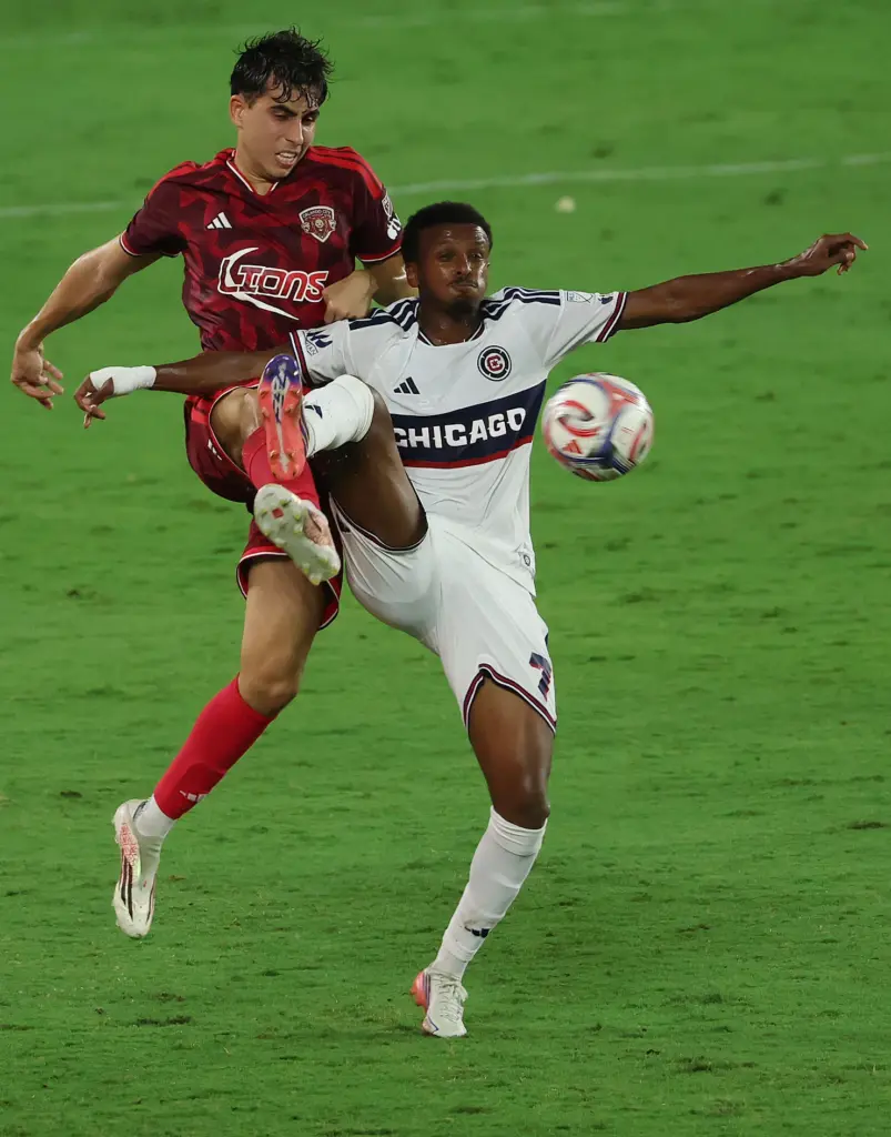 Orlando player Zakaria Taifi (top) tries to get the ball...