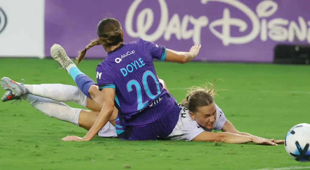 Orlando player Julie Doyle (20) falls along with Louisville player...