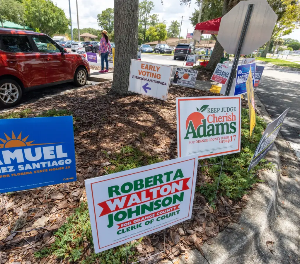 Various campaign signs greet early voters at the Alafaya Branch...