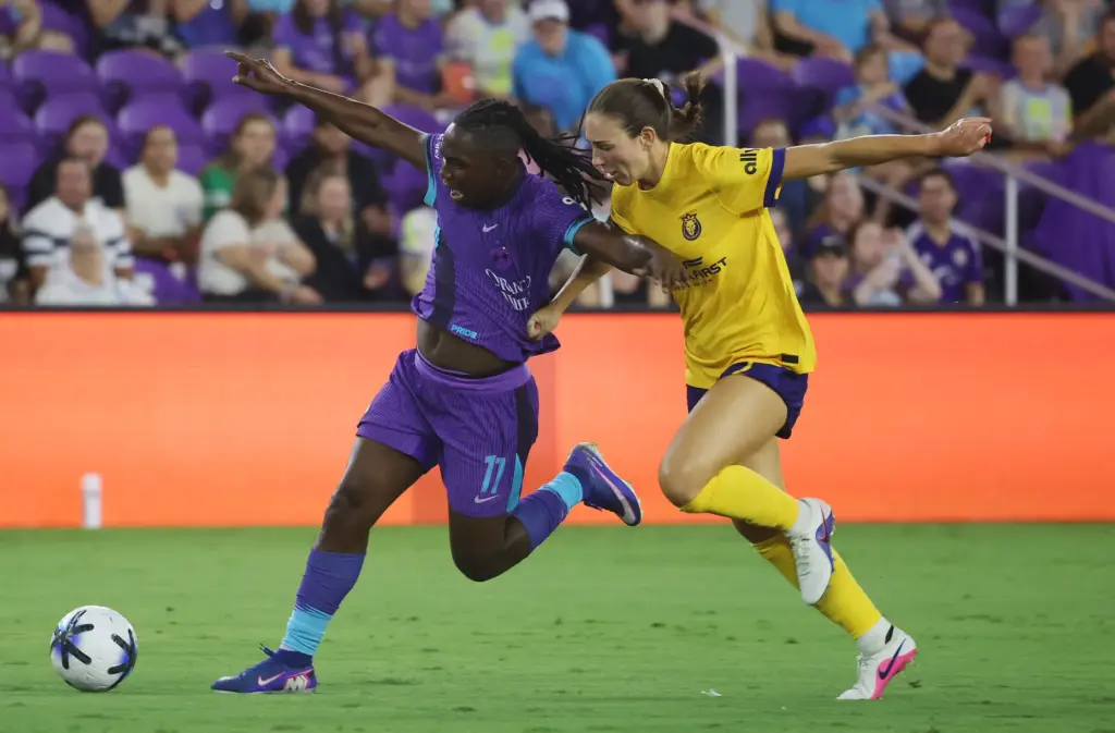 Utah player Tatumn Milazzo (right) fouls Orlando player Barbra Banda...