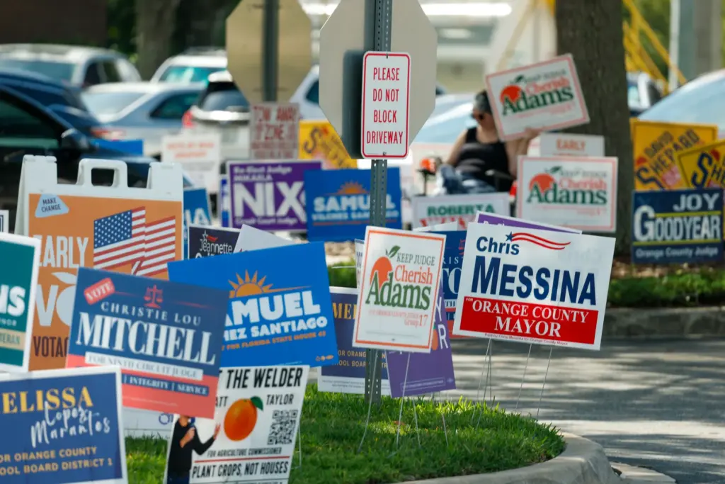 Campaign signs line the entrance to the Alafaya Library in...