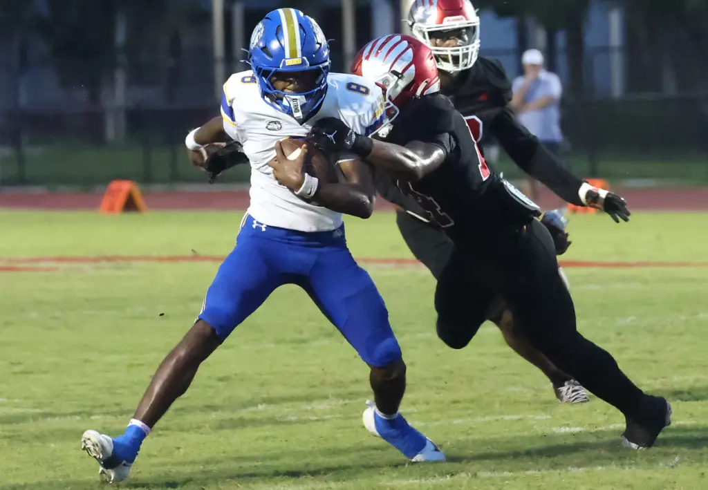 TFA quarterback Deuce Woods Jr. (8) scrambles during the The...