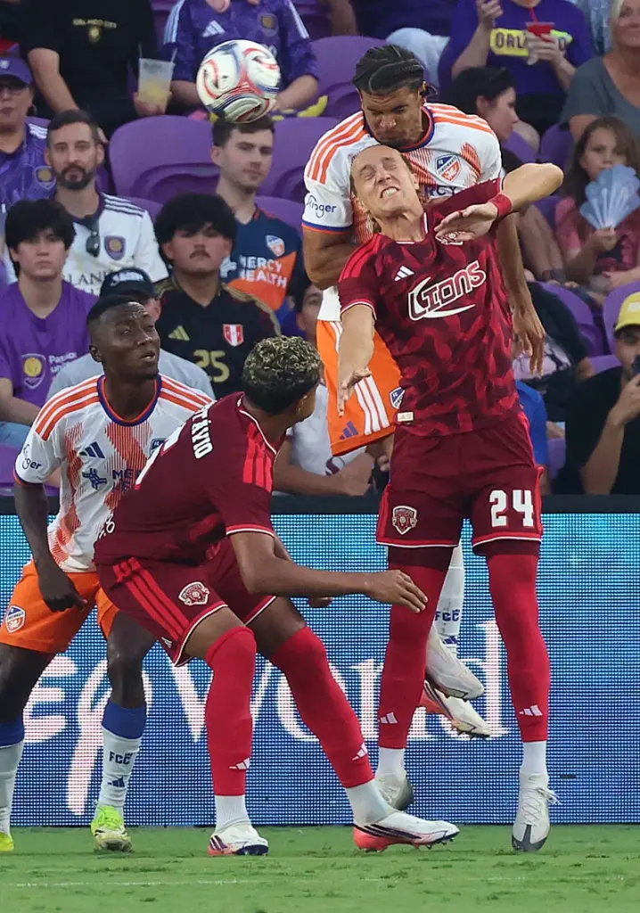 Orlando player Griffin Dorsey (24) leaps to head the ball...