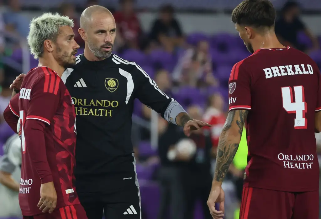 Orlando coach Martin Perelman (middle) coaches players Antoine Griezmann (7)...