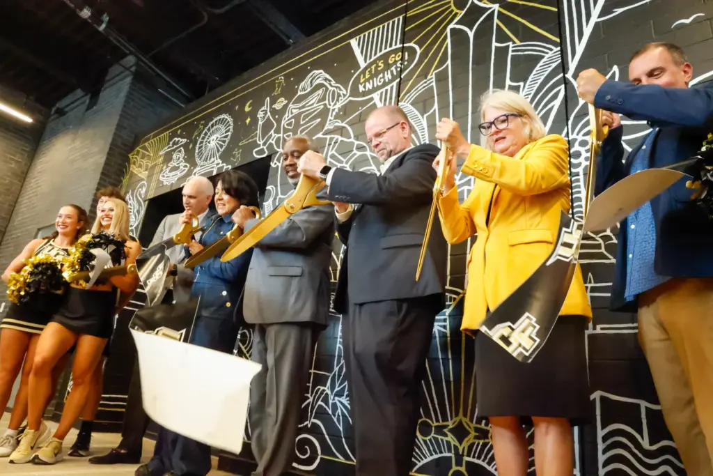 UCF and Orange County officials cut a ceremonial ribbon for...