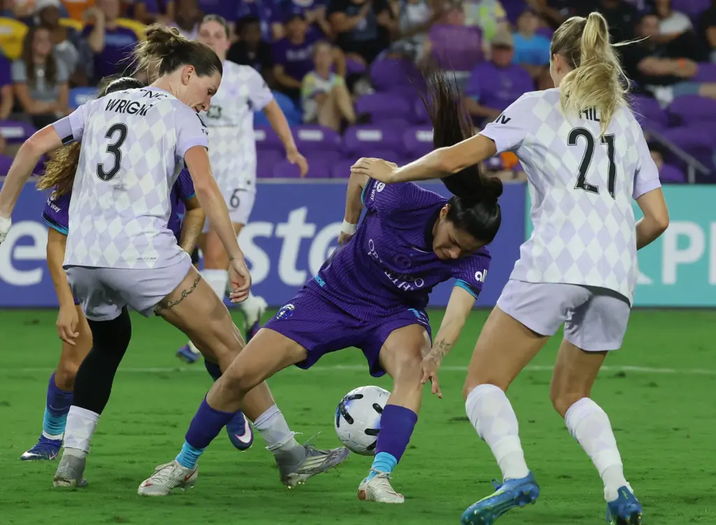 Orlando player Jacquie Ovalle (middle) is hemmed in by Louisville...