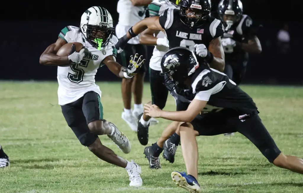 Evans player Charles Jacobs (5) runs during the Evans High...