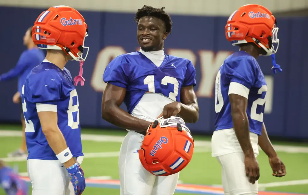University of Florida running back Jadan Baugh (13) smiles beside...