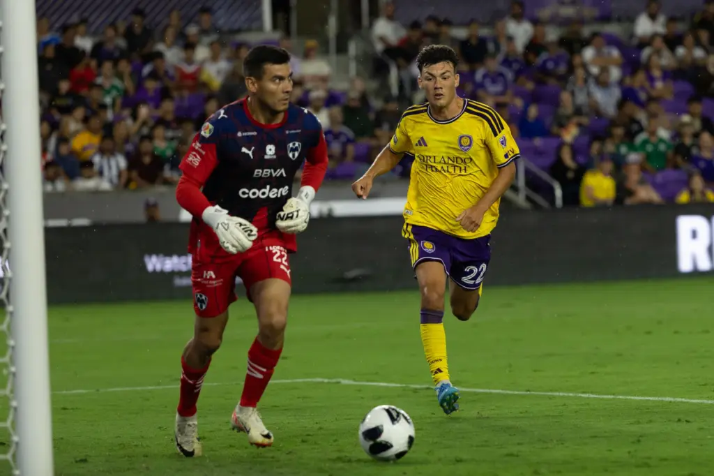 Orlando City player Justin Ellis (22) pressures Monterrey Goalie Luis...