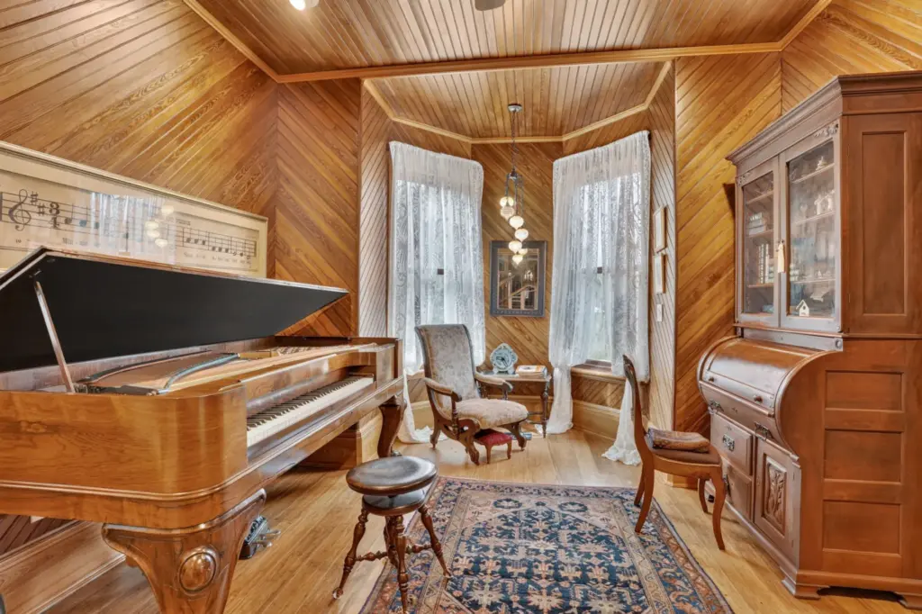 The intimate music room showcases the family’s heirloom Steinway piano....