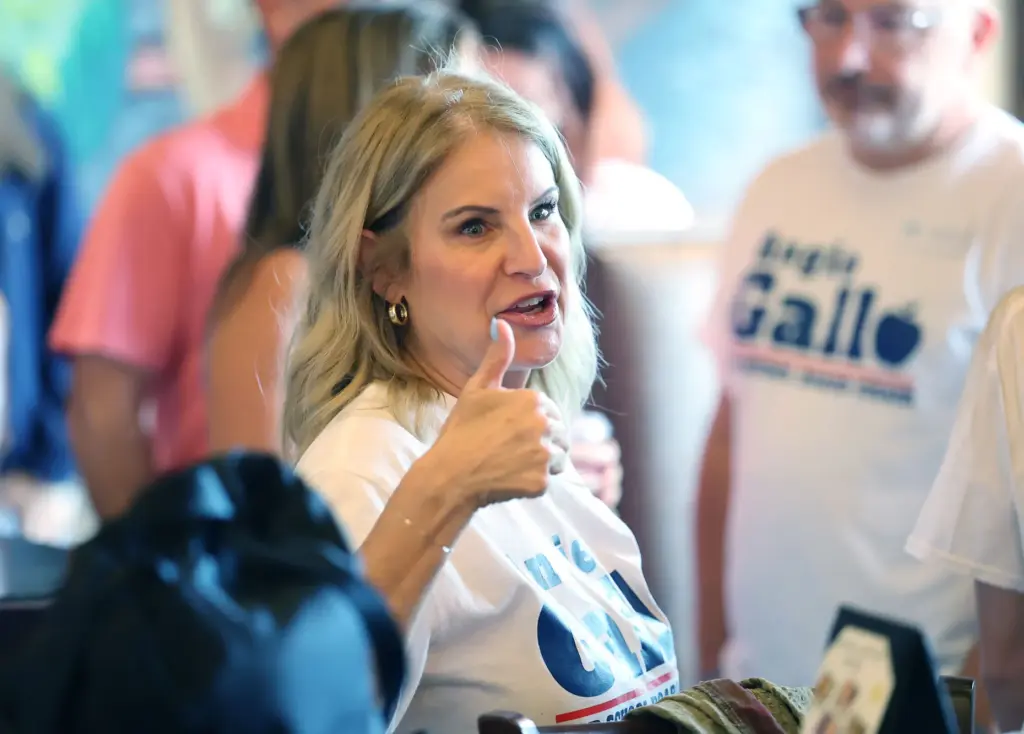 Angie Gallo gives a thumbs up to supporters during her...