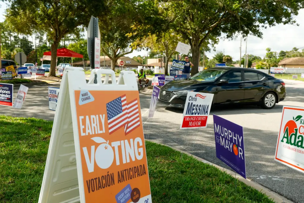 Early voting and campaign signs line the entrance to the...