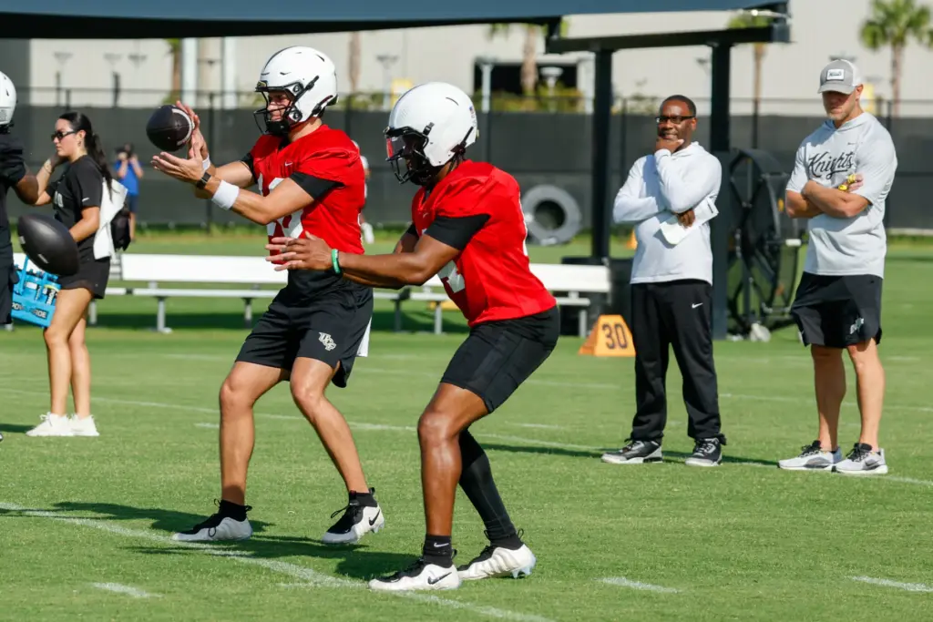 UCF Knights Head Coach Scott Frost oversees Alonza Barnett III...