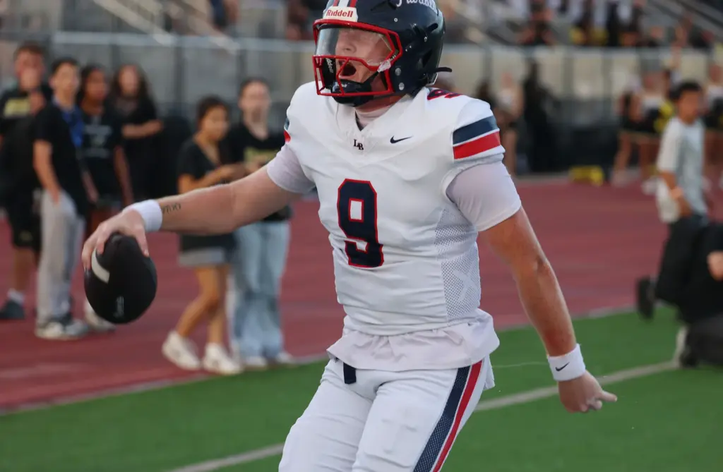 Lake Brantley quarterback Jackson Stecher screams in celebration as he...