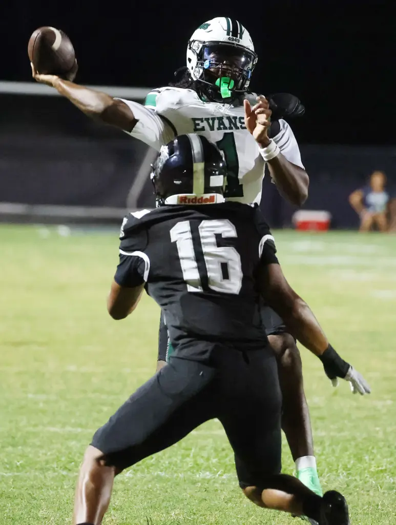 Evans High quarterback William Jackson (1) throws during the Evans...