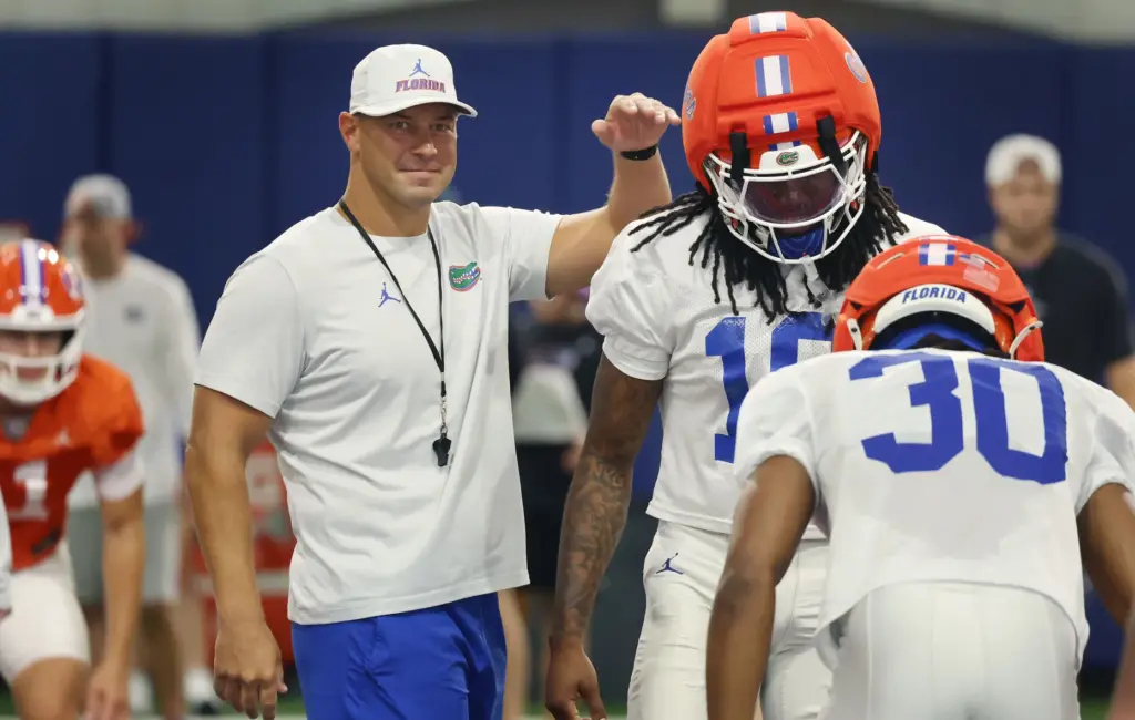 University of Florida head football coach Jon Sumrall encourages players...