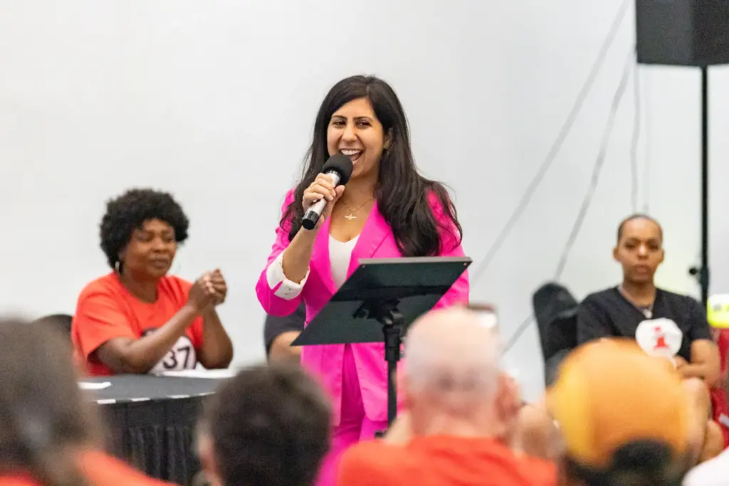 Representative Anna Eskamani hypes up the crowd of Local 737...