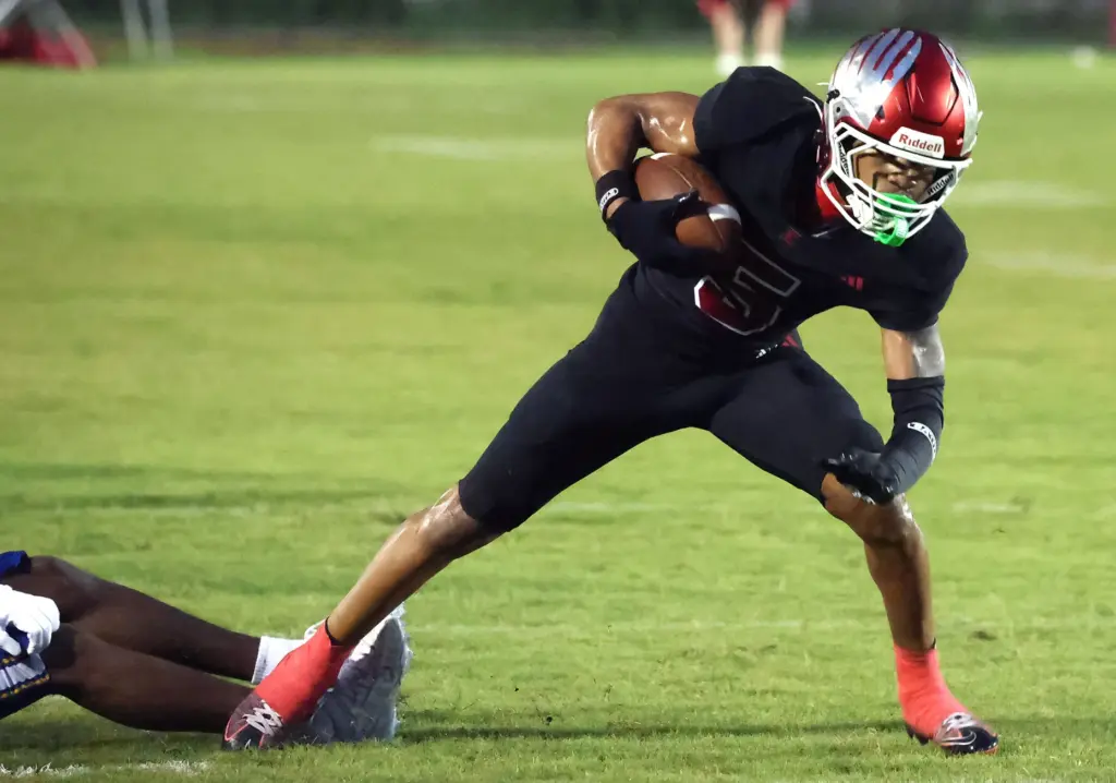 Edgewater athlete Octavius Lewis runs during the The First Academy...