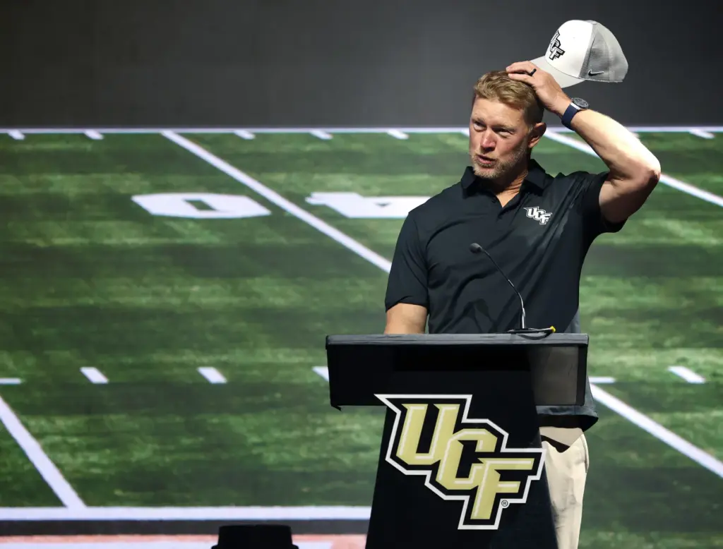 University of Central Florida football coach Scott Frost jokes about...