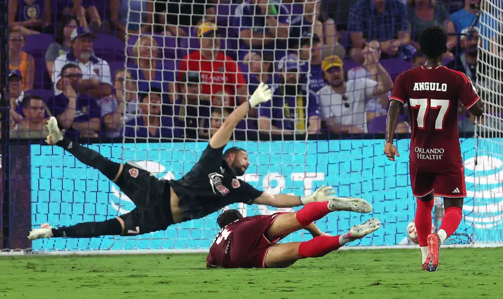 Orlando goalkeeper Maxime Crepeau (71) leaps, but can't stop a...