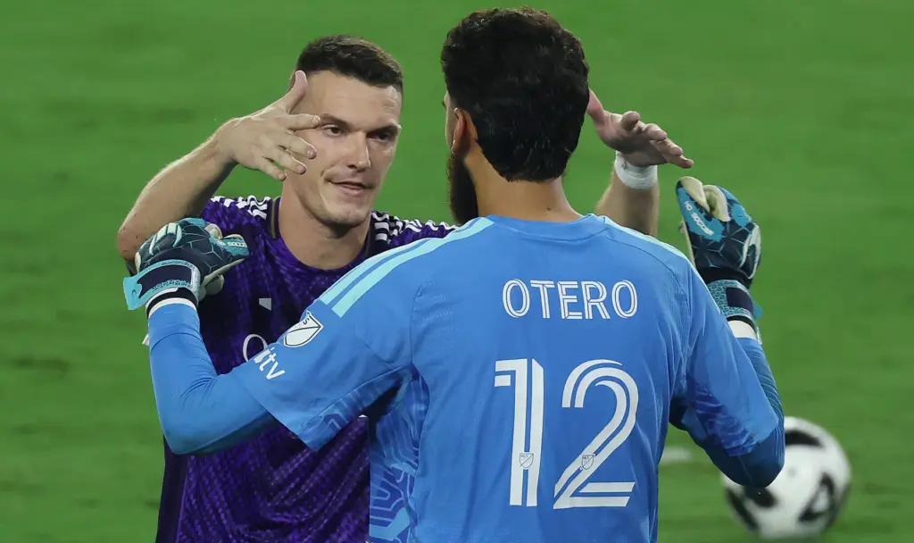 Orlando player Adrian Marin (back) celebrates with Orlando goalkeeper Javier...