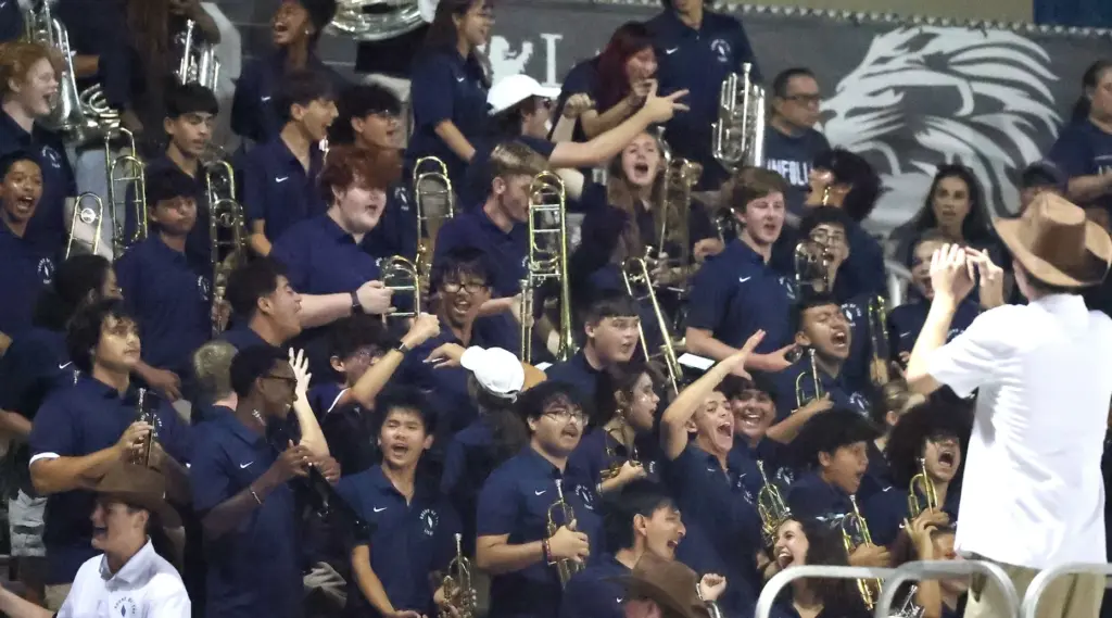 The Lake Nona band cheers during the Evans High at...