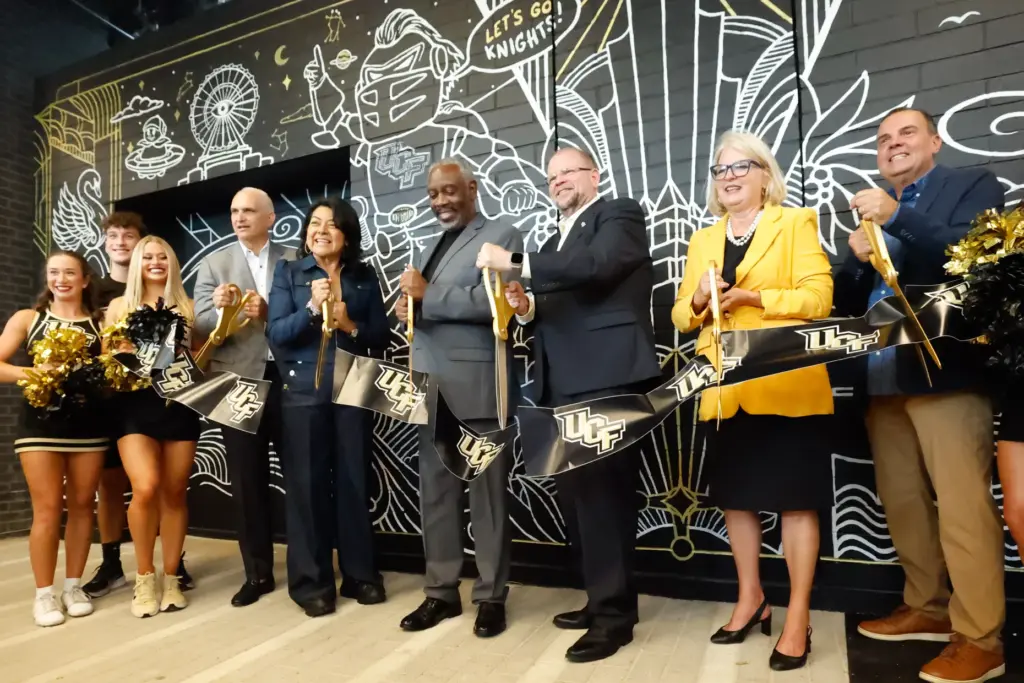 UCF and Orange County officials cut a ceremonial ribbon for...