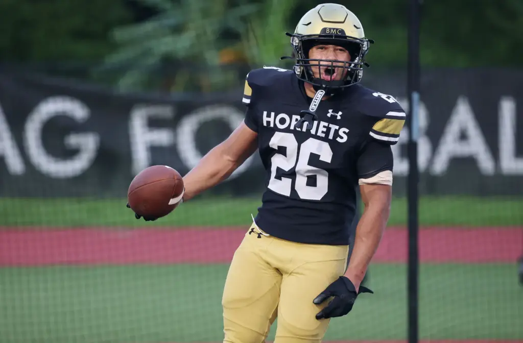 Bishop Moore running back Donovan Ferrufino celebrates after a touchdown...