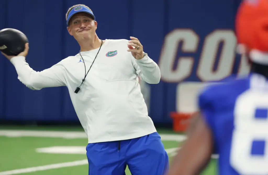 University of Florida offensive coordinator Buster Faulkner throws a ball...