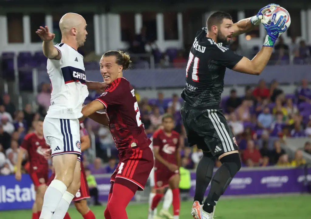 Orlando goalkeeper Maxime Crepeau (71) leaps to stop the ball...