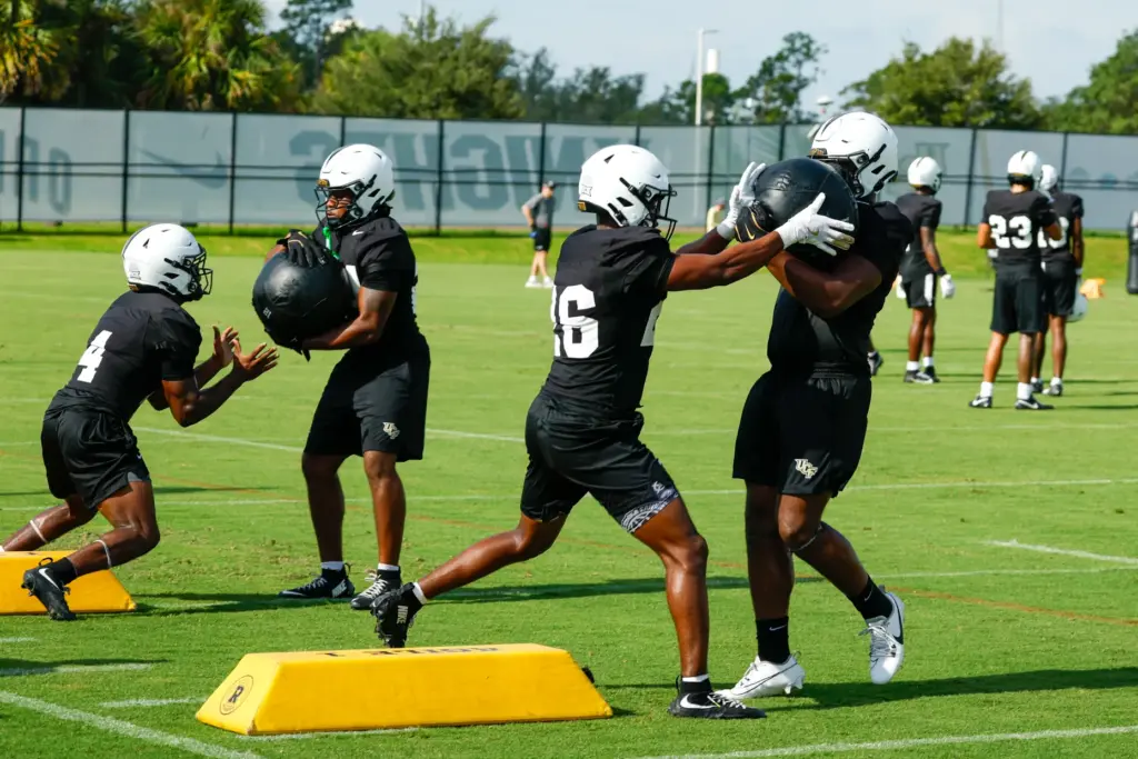 UCF Knights running backs Duke Watson (#26) and Taevion Saint...