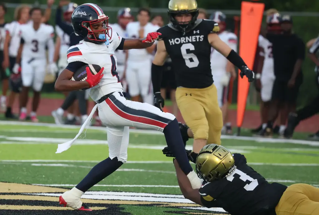 Bishop Moore defensive Nyshaun Drye (3) grabs the leg of...