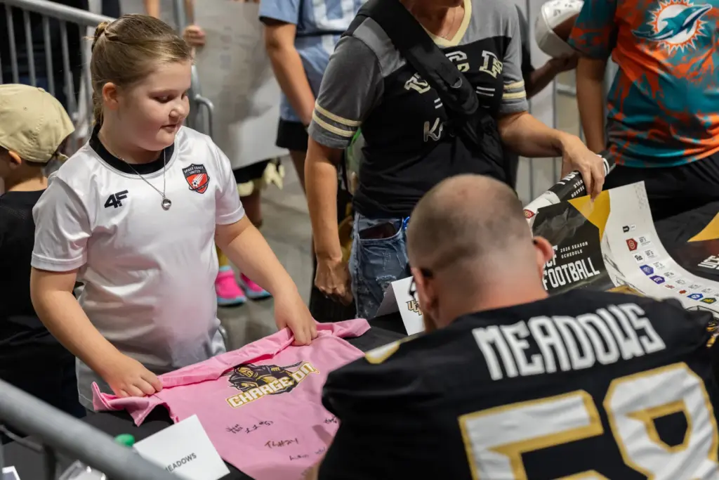 Fan gets an autograph from Knightâs Offensive Lineman Connor Meadows...