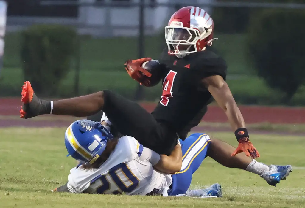 TFA defensive back Brycsen Robb (20) pulls down Edgewater running...