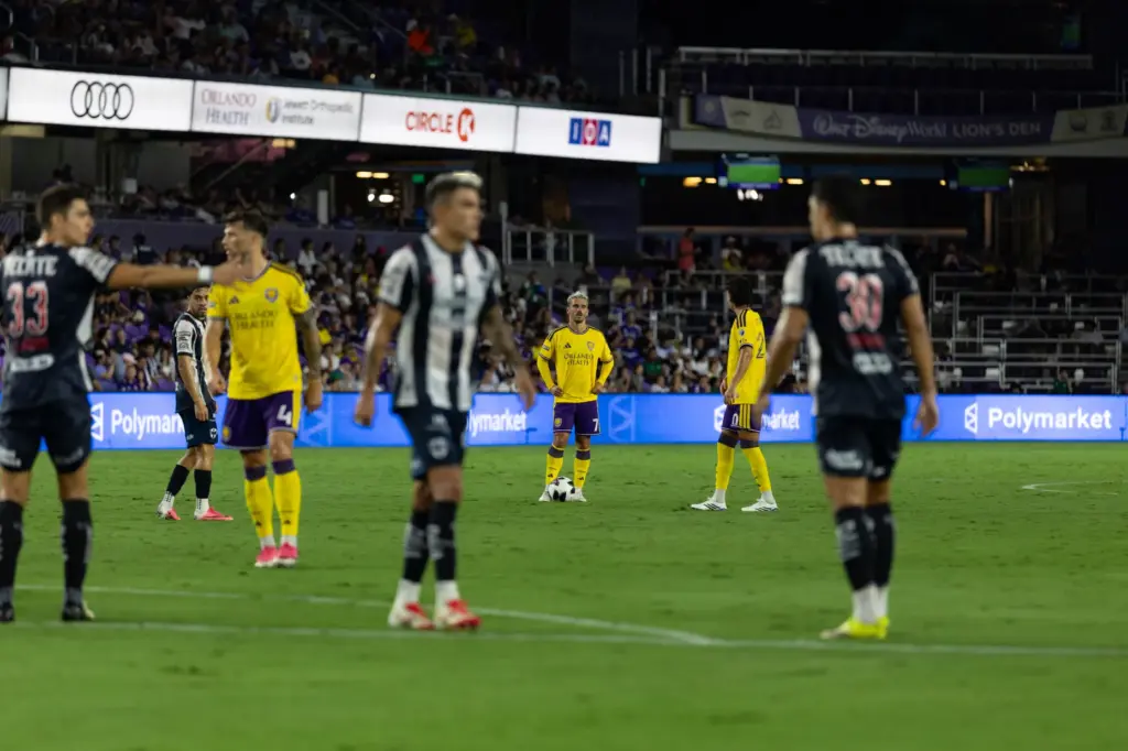 Orlando City player Antoine Griezmann (center) prepares for free kick...