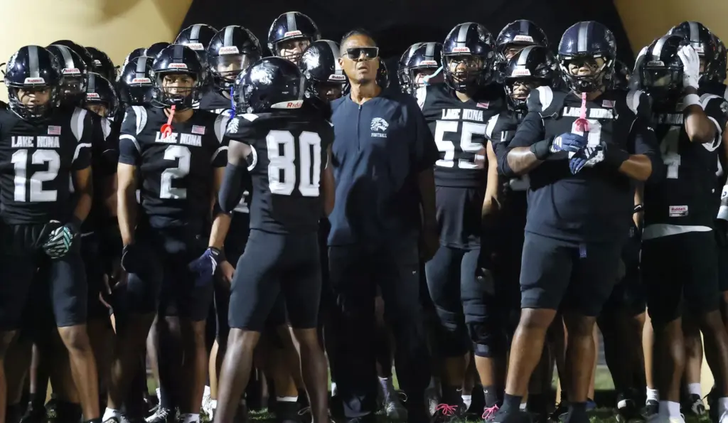 Lake Nona players and coaches are pictured before the Evans...