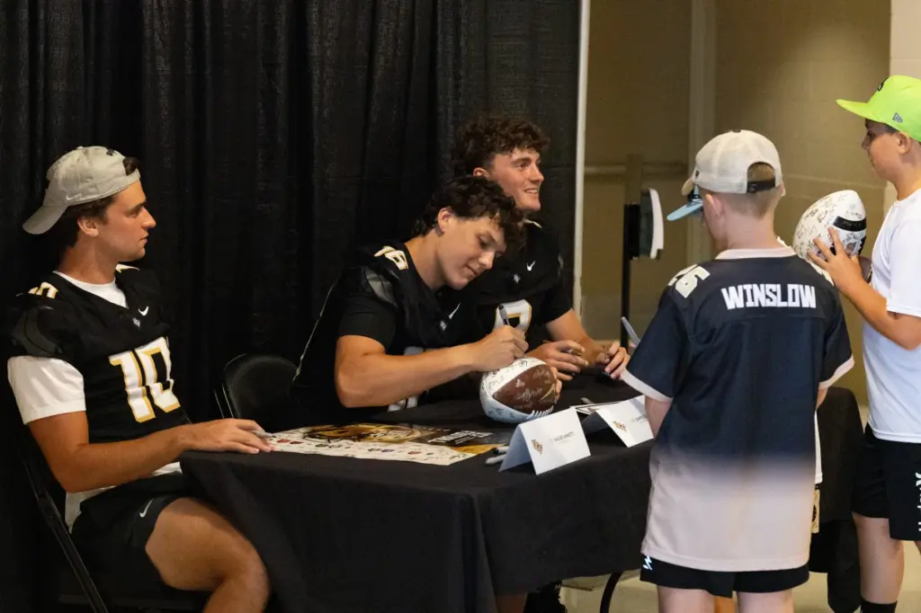 Knightâs Quarterbacks Kaleb Annette, left, Dante Carr, center, and Rocco...