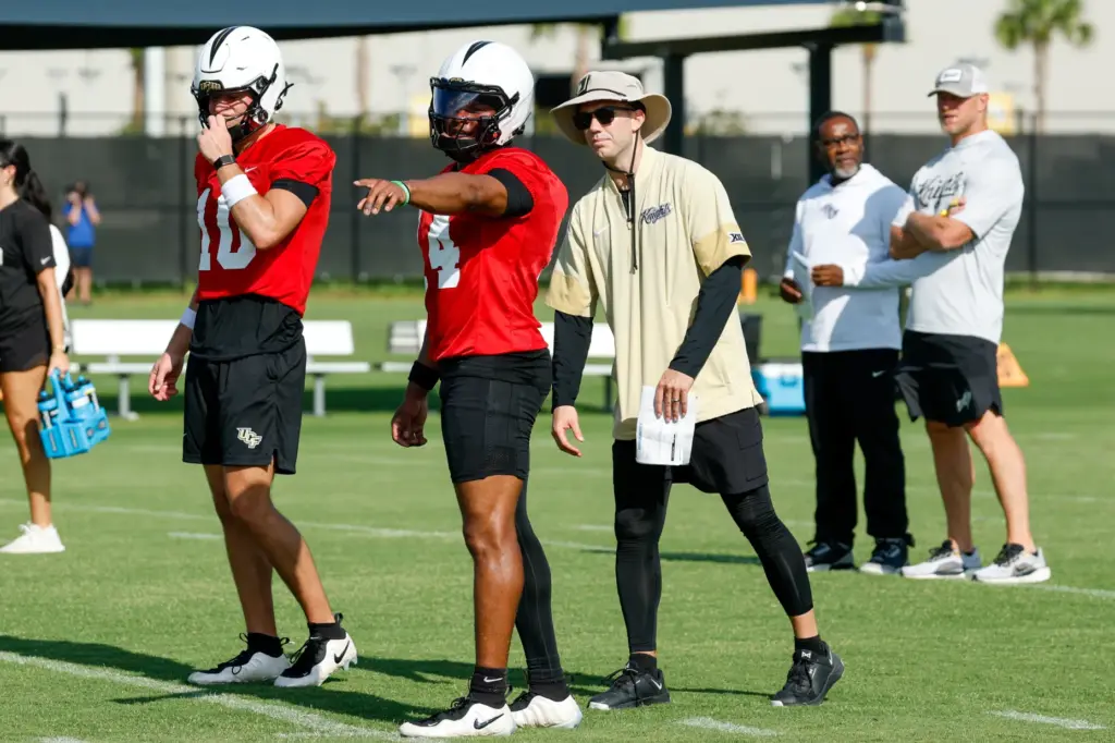 UCF Knights quarterbacks coach McKenzie Milton works with Alonza Barnett...