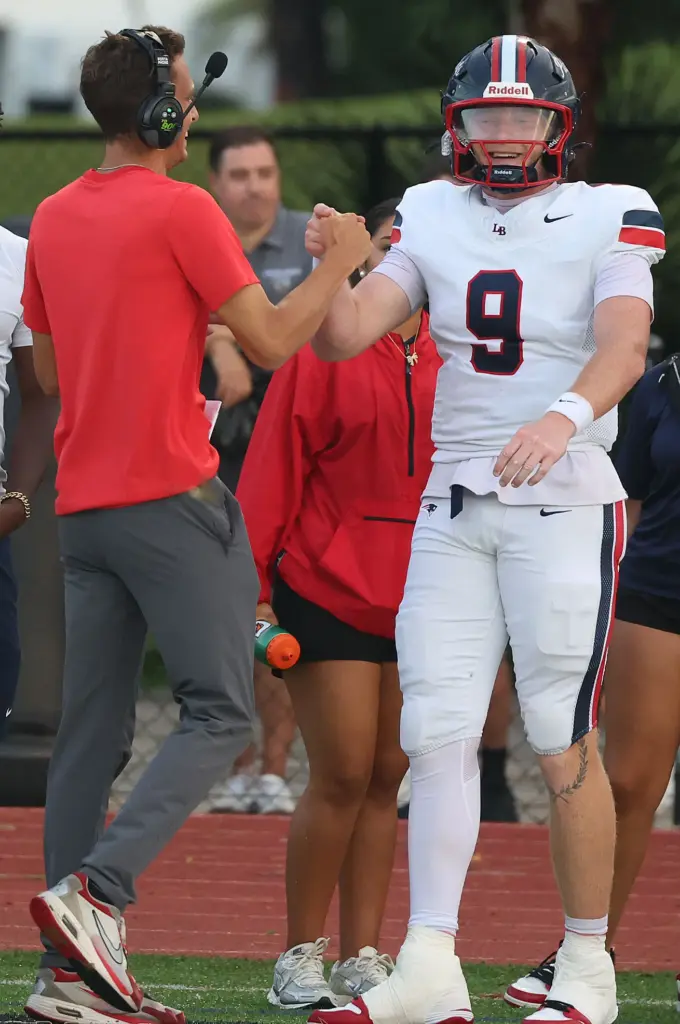 Lake Brantley head coach Garrett Kruczek (left) congratulates quarterback Jackson...